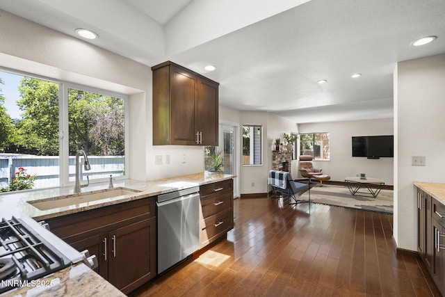 6055 Stonecreek Dr, Reno, NV 89511 - kitchen featuring appliances with stainless steel finishes, light stone counters, dark brown cabinets, open floor plan, and recessed lighting