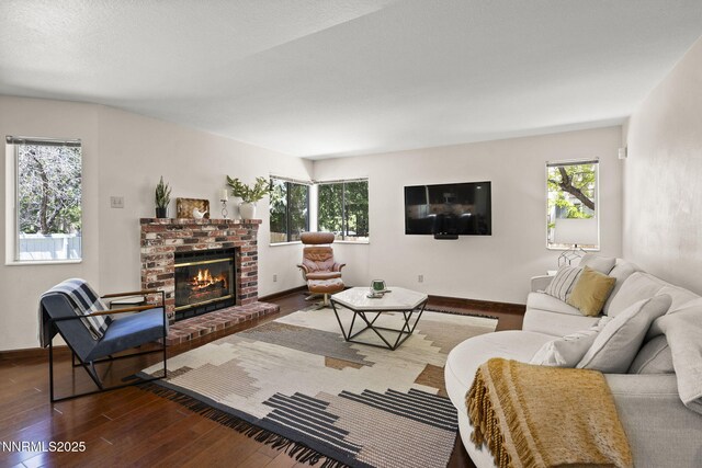 6055 Stonecreek Dr, Reno, NV 89511 - living area with a brick fireplace, wood finished floors, and healthy amount of natural light