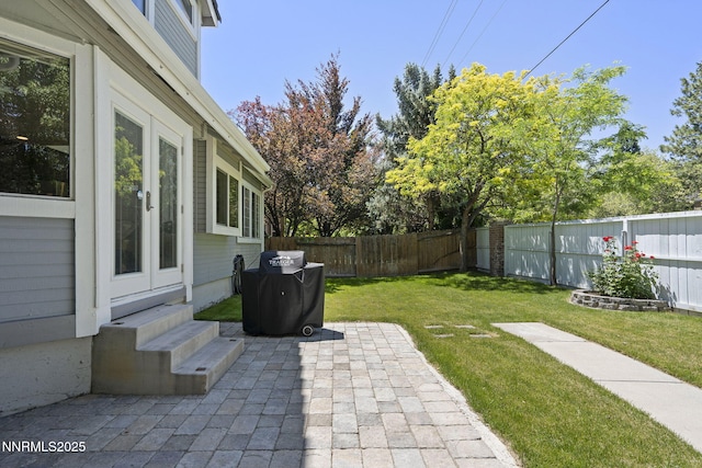 6055 Stonecreek Dr, Reno, NV 89511 - fenced backyard with a patio area, entry steps, grilling area, and french doors
