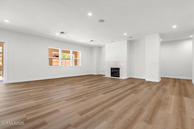 9740 Cardigan Bay Ln, Reno, NV 89521 - unfurnished living room featuring recessed lighting, a fireplace, and light wood-type flooring