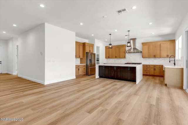 9740 Cardigan Bay Ln, Reno, NV 89521 - kitchen featuring high end refrigerator, wall chimney exhaust hood, light countertops, recessed lighting, and a kitchen island