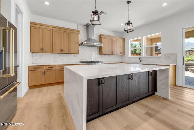 9740 Cardigan Bay Ln, Reno, NV 89521 - kitchen with wall chimney range hood, high end fridge, a center island, light wood-style floors, and recessed lighting