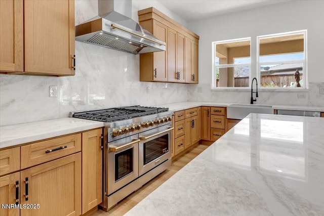 9740 Cardigan Bay Ln, Reno, NV 89521 - kitchen with double oven range, wall chimney exhaust hood, light stone counters, and tasteful backsplash