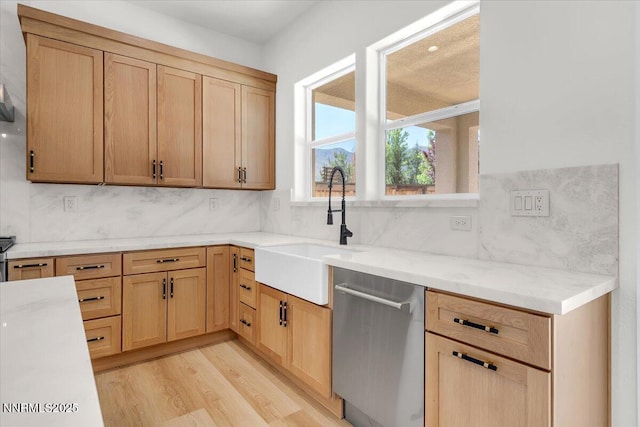9740 Cardigan Bay Ln, Reno, NV 89521 - kitchen with stainless steel dishwasher, light brown cabinets, light wood-type flooring, and backsplash