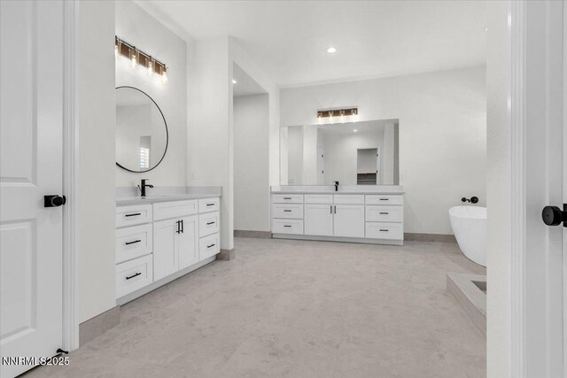 9740 Cardigan Bay Ln, Reno, NV 89521 - full bathroom featuring two vanities, a freestanding bath, and recessed lighting
