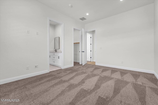 9740 Cardigan Bay Ln, Reno, NV 89521 - unfurnished bedroom with light colored carpet, a spacious closet, recessed lighting, and connected bathroom