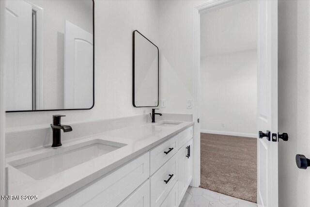 9740 Cardigan Bay Ln, Reno, NV 89521 - bathroom featuring double vanity and baseboards