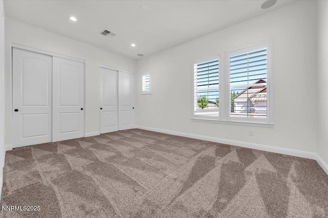 9740 Cardigan Bay Ln, Reno, NV 89521 - unfurnished bedroom featuring two closets, carpet floors, and recessed lighting