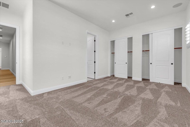 9740 Cardigan Bay Ln, Reno, NV 89521 - unfurnished bedroom featuring two closets, carpet, and recessed lighting