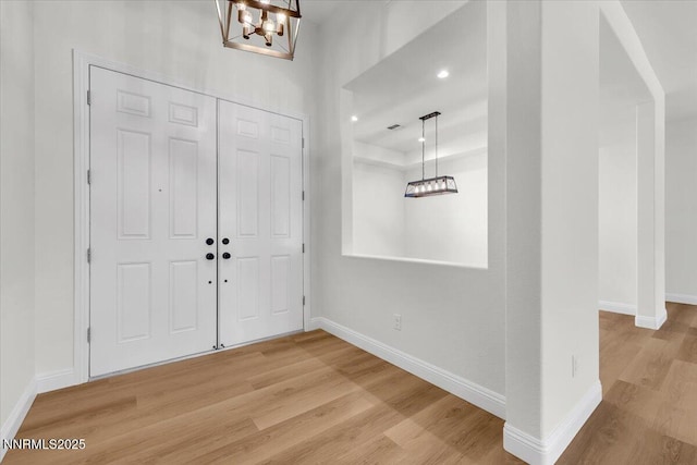 9740 Cardigan Bay Ln, Reno, NV 89521 - foyer featuring a chandelier, wood finished floors, a raised ceiling, and recessed lighting
