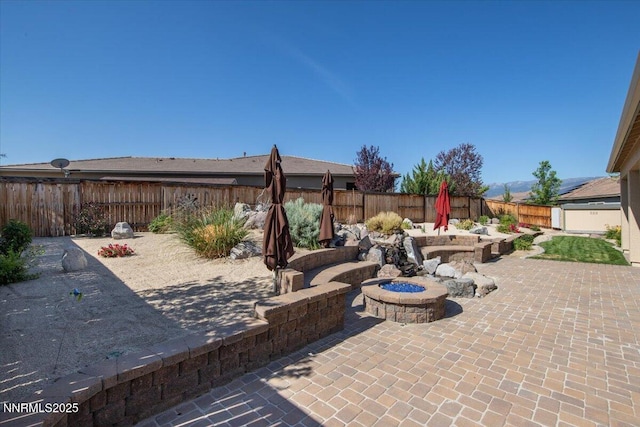 9740 Cardigan Bay Ln, Reno, NV 89521 - fenced backyard with a fire pit and a patio area