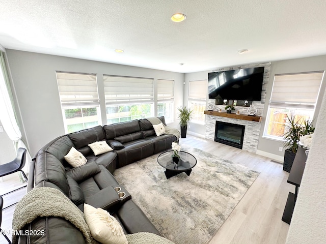 6726 Runnymede Dr, Sparks, NV 89436 - living room featuring plenty of natural light, a textured ceiling, a fireplace, wood finished floors, and recessed lighting