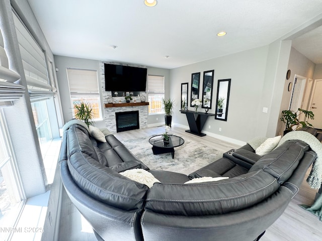 6726 Runnymede Dr, Sparks, NV 89436 - living area with a glass covered fireplace, wood finished floors, recessed lighting, and baseboards
