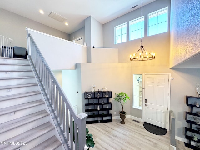 6726 Runnymede Dr, Sparks, NV 89436 - foyer with a chandelier, stairs, wood finished floors, a towering ceiling, and baseboards