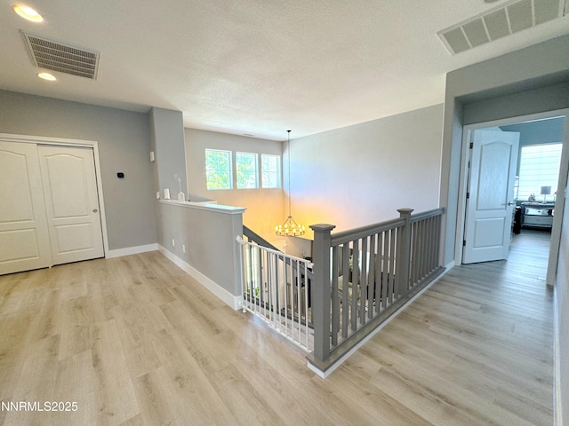 6726 Runnymede Dr, Sparks, NV 89436 - hallway with wood finished floors, recessed lighting, an upstairs landing, baseboards, and a chandelier