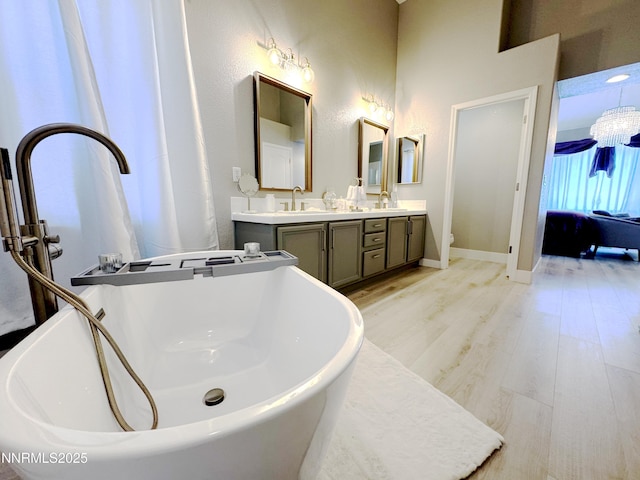 6726 Runnymede Dr, Sparks, NV 89436 - full bath featuring double vanity, a soaking tub, wood finished floors, baseboards, and toilet