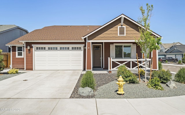 1661 Buttonwillow St, Minden, NV 89423 - view of front of house featuring a garage, concrete driveway, and a porch