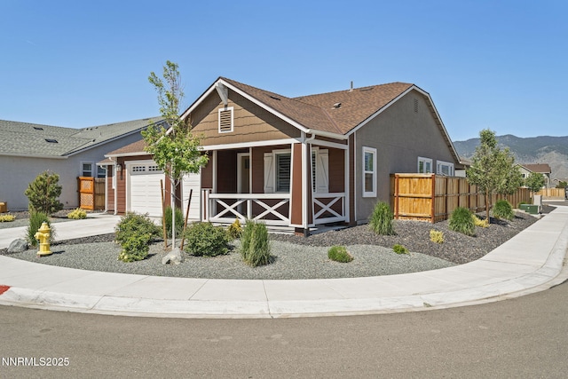 1661 Buttonwillow St, Minden, NV 89423 - view of front of house with an attached garage, covered porch, a mountain view, and driveway