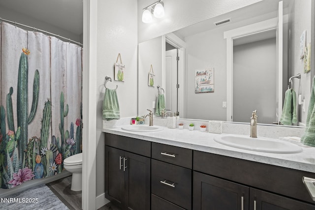 1661 Buttonwillow St, Minden, NV 89423 - full bath featuring toilet, double vanity, a shower with curtain, and wood finished floors