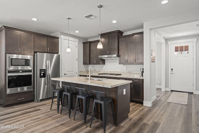 1661 Buttonwillow St, Minden, NV 89423 - kitchen with appliances with stainless steel finishes, a sink, dark brown cabinetry, wood finished floors, and recessed lighting
