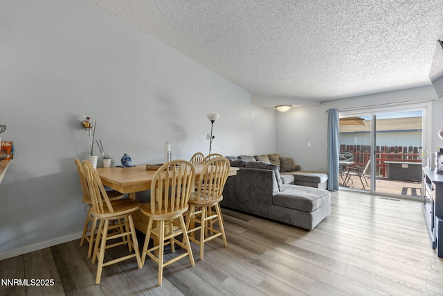 11050 Zeolite Dr, Reno, NV 89506 - dining area featuring a textured ceiling and wood finished floors