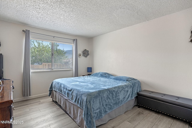 11050 Zeolite Dr, Reno, NV 89506 - bedroom with light wood-style flooring, a textured ceiling, and baseboards