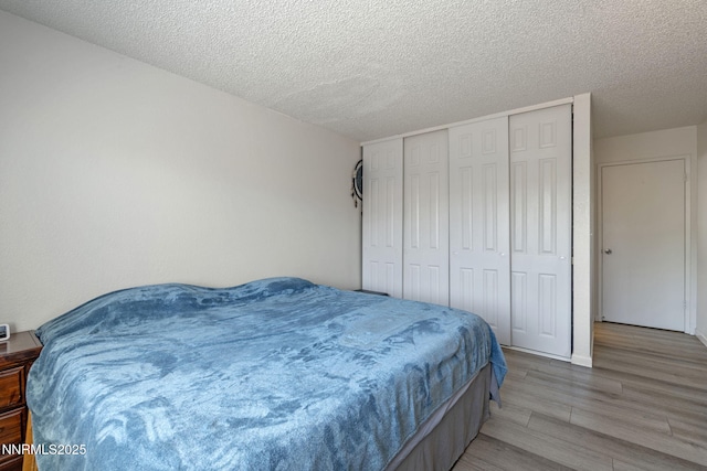 11050 Zeolite Dr, Reno, NV 89506 - bedroom with light wood-type flooring, a textured ceiling, and a closet