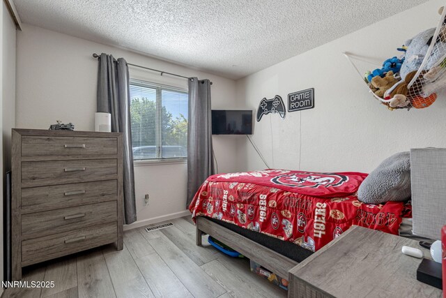 11050 Zeolite Dr, Reno, NV 89506 - bedroom with a textured ceiling, wood finished floors, and baseboards