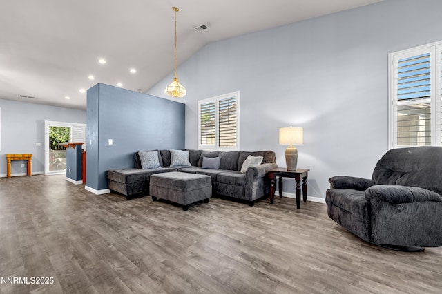 8975 Sorcha St, Reno, NV 89506 - living room featuring wood finished floors, baseboards, lofted ceiling, and recessed lighting