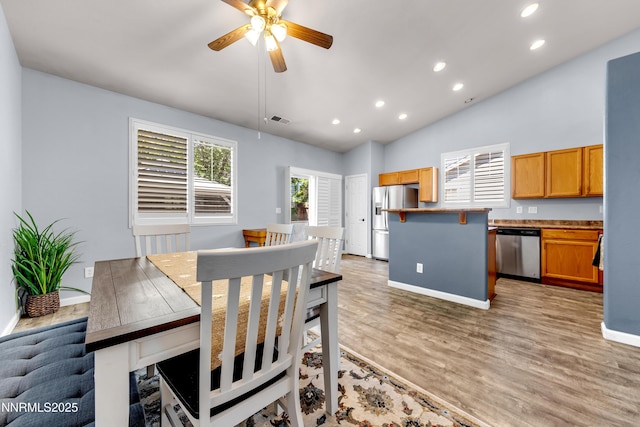 8975 Sorcha St, Reno, NV 89506 - dining room featuring recessed lighting, baseboards, a ceiling fan, light wood finished floors, and vaulted ceiling