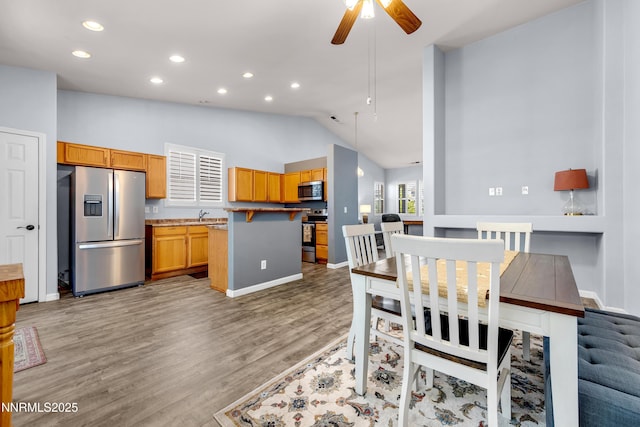 8975 Sorcha St, Reno, NV 89506 - dining room with ceiling fan, lofted ceiling, light wood-style flooring, baseboards, and recessed lighting
