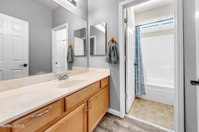 8975 Sorcha St, Reno, NV 89506 - full bath with vanity, shower / bath combo with shower curtain, wood finished floors, and baseboards