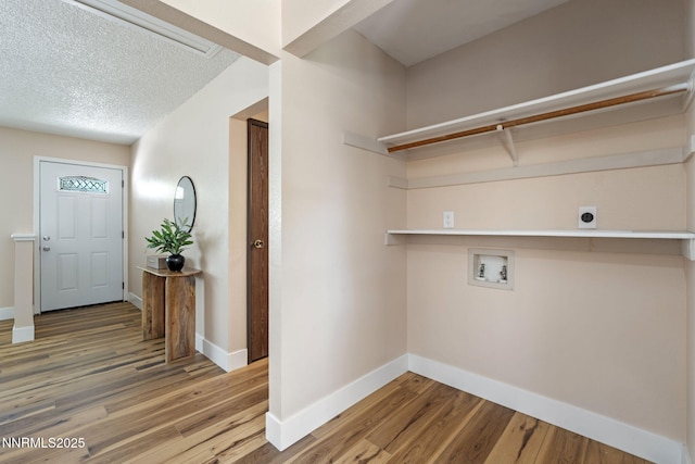 295 Sandia Dr, Fernley, NV 89408 - laundry area with hookup for an electric dryer, hookup for a washing machine, wood finished floors, baseboards, and a textured ceiling