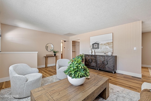 295 Sandia Dr, Fernley, NV 89408 - living area with wood finished floors, baseboards, and a textured ceiling
