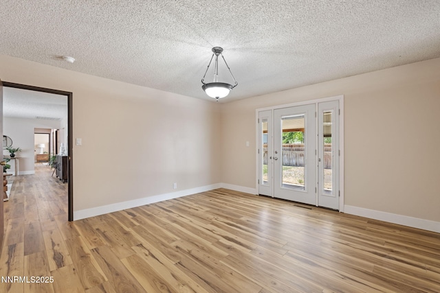 295 Sandia Dr, Fernley, NV 89408 - spare room featuring light wood-style floors, a textured ceiling, baseboards, and a smoke detector
