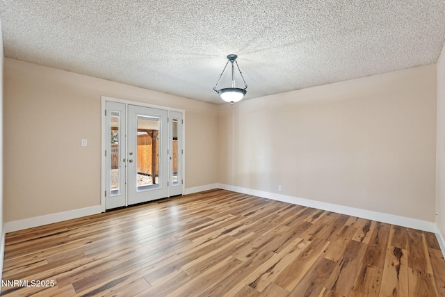 295 Sandia Dr, Fernley, NV 89408 - unfurnished room with wood finished floors, baseboards, and a textured ceiling