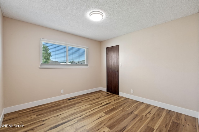 295 Sandia Dr, Fernley, NV 89408 - unfurnished room with wood finished floors, a textured ceiling, and baseboards