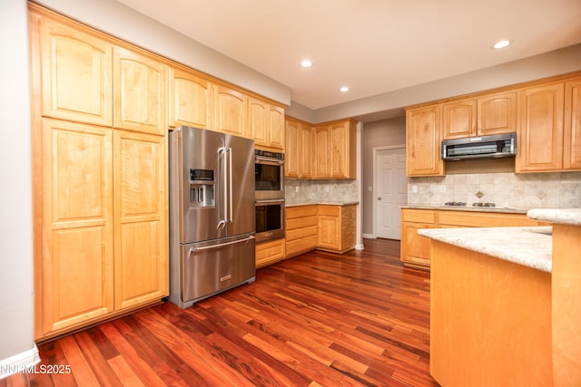 867 Mahogany Dr, Minden, NV 89423 - kitchen featuring appliances with stainless steel finishes, light brown cabinetry, dark wood-style flooring, recessed lighting, and light stone counters