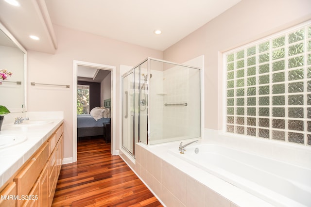 867 Mahogany Dr, Minden, NV 89423 - full bathroom featuring a garden tub, a stall shower, wood finished floors, double vanity, and recessed lighting