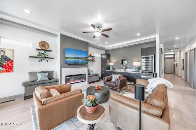 1536 Elk Run Trl, Reno, NV 89523 - living area with a ceiling fan, wine cooler, a glass covered fireplace, recessed lighting, and light wood-style floors