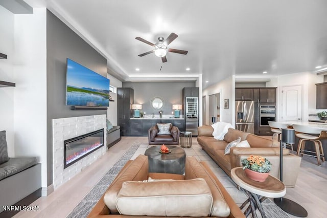 1536 Elk Run Trl, Reno, NV 89523 - living room featuring a ceiling fan, a glass covered fireplace, recessed lighting, and light wood finished floors