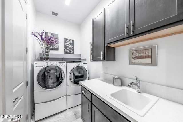 1536 Elk Run Trl, Reno, NV 89523 - laundry room featuring washer and dryer, cabinet space, and light wood-style flooring