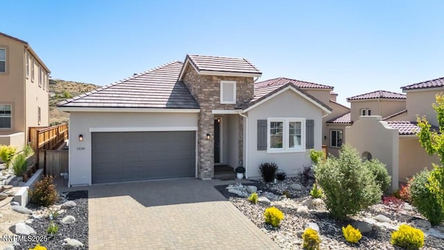 1536 Elk Run Trl, Reno, NV 89523 - view of front of property with stone siding, an attached garage, stucco siding, and a tiled roof