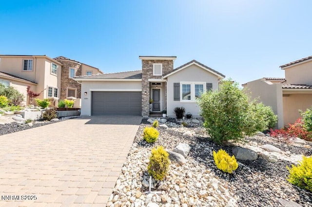 1536 Elk Run Trl, Reno, NV 89523 - view of front of house featuring decorative driveway, stucco siding, an attached garage, and stone siding
