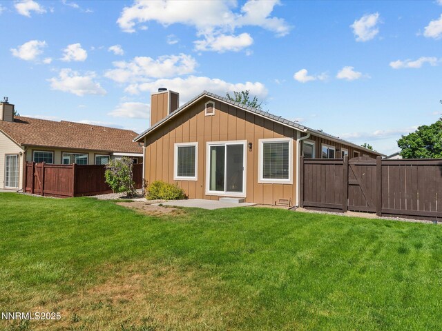 1772 Shamrock Cir, Minden, NV 89423 - rear view of property with a chimney, board and batten siding, a gate, and a patio