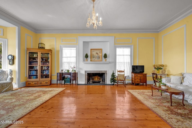 2350 Jacks Valley Rd, Genoa, NV 89411 - living area with ornamental molding, plenty of natural light, a fireplace with flush hearth, a chandelier, and hardwood / wood-style flooring