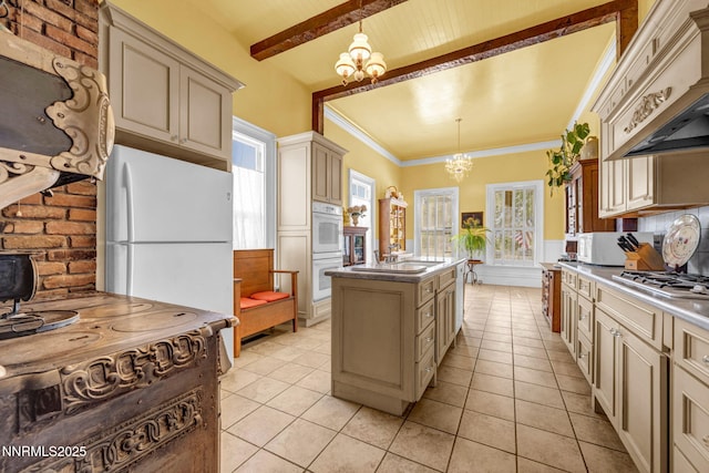 2350 Jacks Valley Rd, Genoa, NV 89411 - kitchen featuring cream cabinets, custom range hood, a chandelier, a center island, and white appliances