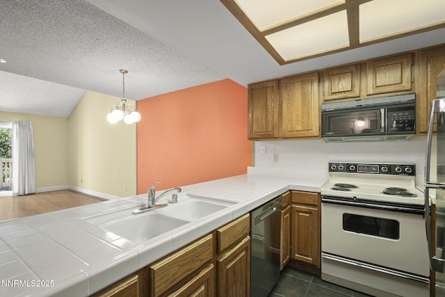2875 Idlewild Dr Unit 106, Reno, NV 89509 - kitchen featuring black microwave, electric stove, stainless steel dishwasher, a sink, and tile counters