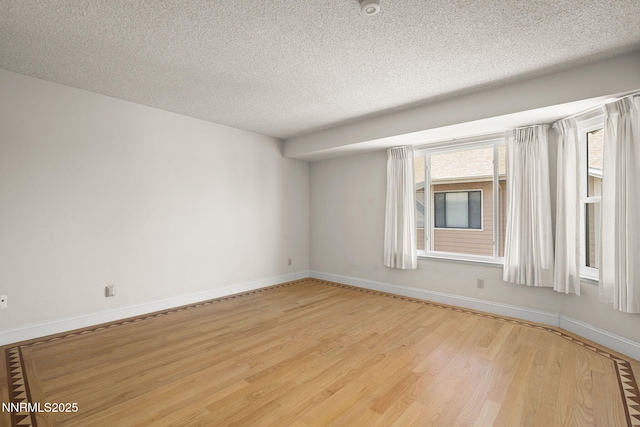 2875 Idlewild Dr Unit 106, Reno, NV 89509 - empty room featuring light wood-style flooring, a textured ceiling, and baseboards