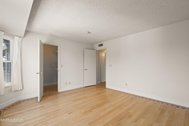 2875 Idlewild Dr Unit 106, Reno, NV 89509 - unfurnished room with light wood-style flooring, a textured ceiling, and baseboards